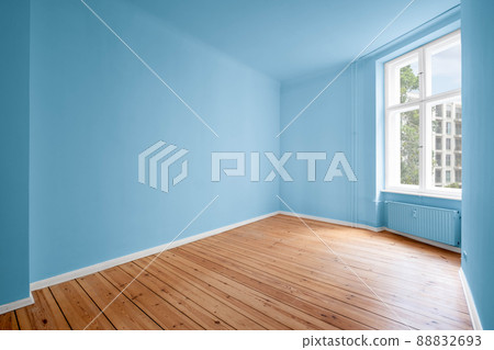 room with wooden floor and blue painted walls 88832693