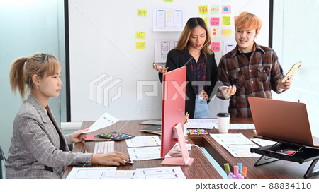 User experience designers are brainstorming and planning sketch, prototype, framework, layout future app design project together. 88834110