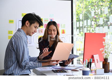 User experience designers team are brainstorming and planning sketch, prototype, framework, layout app design project at office. User experience designers team are brainstorming and planning sketch, prototype, framework, layout app design project at office. 88834111