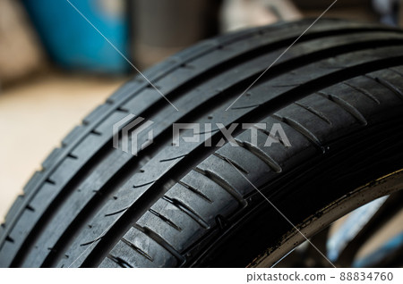 Close-up of a new car tire with a tread. 88834760