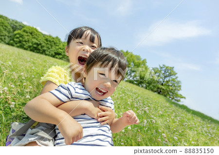 Sister and brother playing in the park Sister and brother playing in the park 88835150