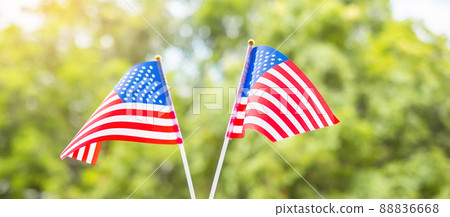 hand holding United States of America flag on green background. USA holiday of Veterans, Memorial, Independence ( Fourth of July) and Labor Day concept 88836668