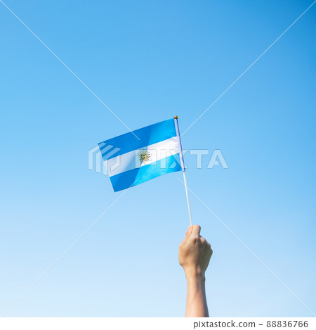 hand holding Argentina flag on nature background. 9th July of Independence day, 25th May of Revolution day and happy celebration concepts hand holding Argentina flag on nature background. 9th July of Independence day, 25th May of Revolution day and happy celebration concepts 88836766