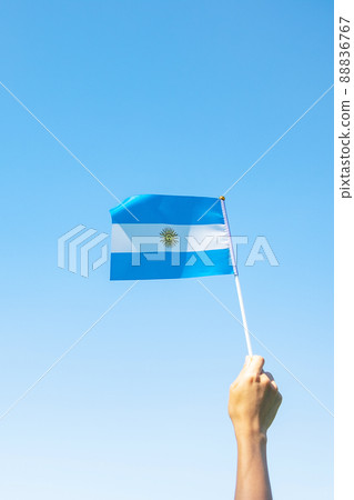 hand holding Argentina flag on nature background. 9th July of Independence day, 25th May of Revolution day and happy celebration concepts hand holding Argentina flag on nature background. 9th July of Independence day, 25th May of Revolution day and happy celebration concepts 88836767