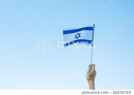 hand holding Israel flag on nature background. Israel Independence day and happy celebration concepts hand holding Israel flag on nature background. Israel Independence day and happy celebration concepts 88836768