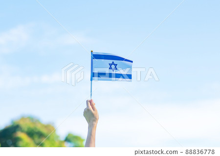 hand holding Israel flag on nature background. Israel Independence day and happy celebration concepts hand holding Israel flag on nature background. Israel Independence day and happy celebration concepts 88836778