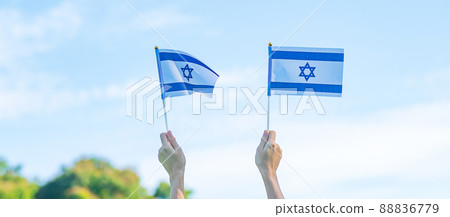 hand holding Israel flag on nature background. Israel Independence day and happy celebration concepts hand holding Israel flag on nature background. Israel Independence day and happy celebration concepts 88836779