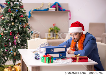 Young businessman working from home at Christmas eve Young businessman working from home at Christmas eve 88836782