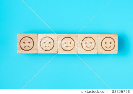 emotion face symbol blocks on blue background. Service rating, ranking, customer review, satisfaction, evaluation and feedback concept emotion face symbol blocks on blue background. Service rating, ranking, customer review, satisfaction, evaluation and feedback concept 88836798