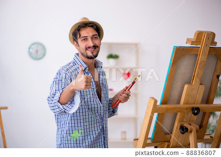 Young man enjoying painting at the studio 88836807