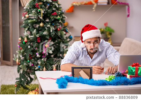 Young man celebrating Christmas at home alone 88836809