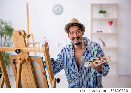 Young man enjoying painting at the studio 88836810