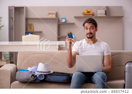 Young man preparing for trip at home 88837412