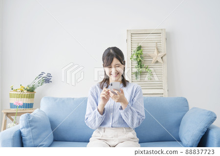 Female smartphone living room Female smartphone living room 88837723