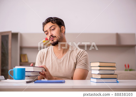 Young male student studying at home during pandemic Young male student studying at home during pandemic 88838103