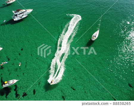 Aerial panoramic view of seascape with crystal clear azure sea and rocky shores. Yachts in a beautiful lagoon on backdrop of rocks. The concept of an ideal destination for summer travel and vacation. Aerial panoramic view of seascape with crystal clear azure sea and rocky shores. Yachts in a beautiful lagoon on backdrop of rocks. The concept of an ideal destination for summer travel and vacation. 88838265