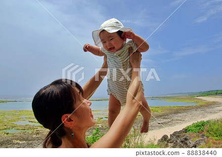 A baby pleading for a high height at the beach in Okinawa A baby pleading for a high height at the beach in Okinawa 88838440