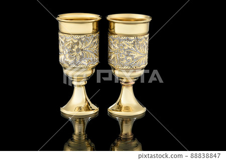 Antique Vintage Brass Shot Glass Gilded on Black background Antique Vintage Brass Shot Glass Gilded on Black background 88838847