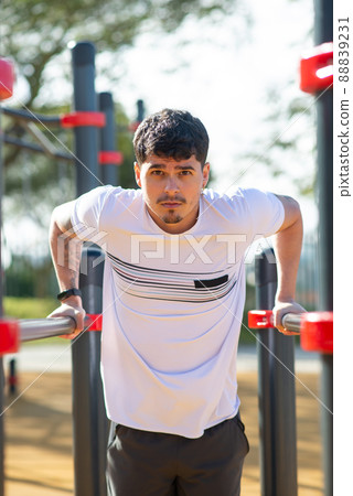 Handsome sportsman working out on sunny day Handsome sportsman working out on sunny day 88839231