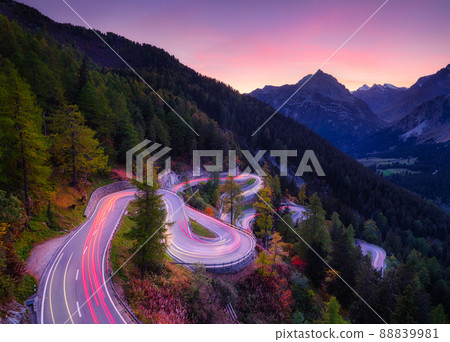 The mountain pass of Maloja, Switzerland. A road with many curves among the forest.  88839981