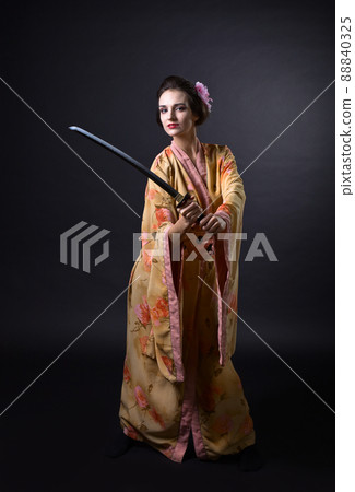Woman in kimono with sword. Woman in kimono with sword. 88840325