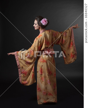 Dancing woman in traditional Japanese kimono on a black background. 88840327