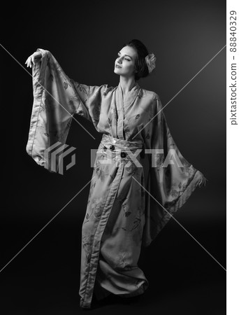Dancing woman in traditional Japanese kimono on black background 88840329