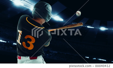Back view of professional baseball player with baseball bat in action during match at stadium at evening time. Sport, win, winner, competition concept. 88840412