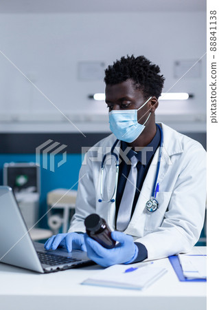 Clinic medic expert verifying prescribed painkillers allergens using workplace laptop. Clinic specialist doctor consulting medicine ingredients and patient illness symptom report file. Clinic medic expert verifying prescribed painkillers allergens using workplace laptop. Clinic specialist doctor consulting medicine ingredients and patient illness symptom report file. 88841138