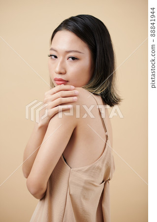 Young Woman Touching Shoulder 88841944