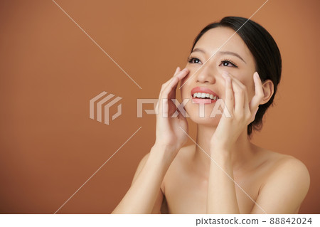 Woman Applying Depuffing Undereye Moisturizer Woman Applying Depuffing Undereye Moisturizer 88842024