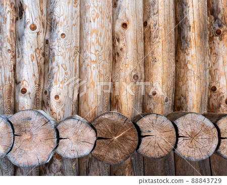 Log house wall background. Construction of a wooden eco-friendly house from natural materials. Pattern and texture of wood masonry Log house wall background. Construction of a wooden eco-friendly house from natural materials. Pattern and texture of wood masonry 88843729