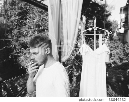 The groom goes from the bride, wedding day, photo shoot Black and white grain effect The groom goes from the bride, wedding day, photo shoot Black and white grain effect 88844282