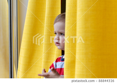 Little boy looking out the window. Close-up. Little boy looking out the window. Close-up. 88844316