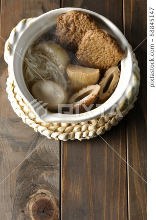 A bird's-eye view of hot oden for one person containing boiled eggs, radishes, chikuwa, Jakoten, Shirataki, and kamaboko. 88845147