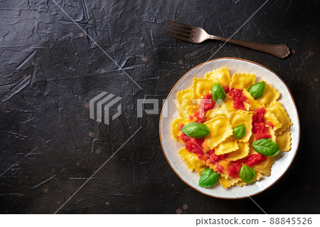 Ravioli with tomato sauce and basil. A plate of stuffed pasta 88845526