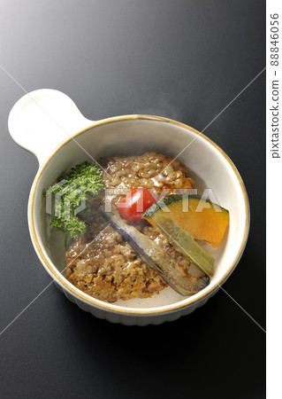 Coarse hot hamburger steak with stewed vegetables and parsley (black background) Coarse hot hamburger steak with stewed vegetables and parsley (black background) 88846056
