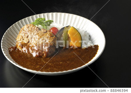 Photographed a hot hamburger curry with stewed vegetables and parsley on a black background Photographed a hot hamburger curry with stewed vegetables and parsley on a black background 88846394