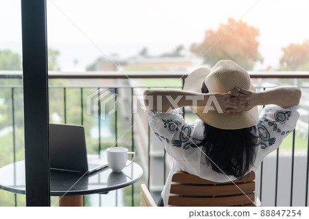 Work-Life balance, life quality, work from home and travel concept with business woman relaxing, take it easy, resting in  hotel resort, condominium, or apartment luxury living room with notebook 88847254