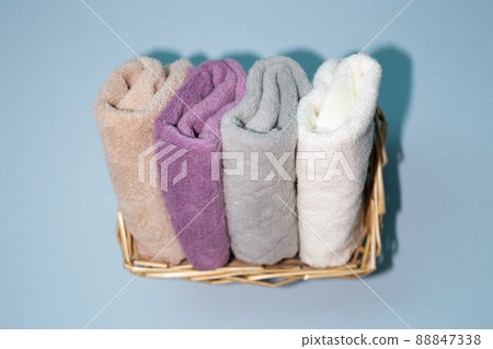 Bath towels in basket on blue background. top view, copy space Bath towels in basket on blue background. top view, copy space 88847338