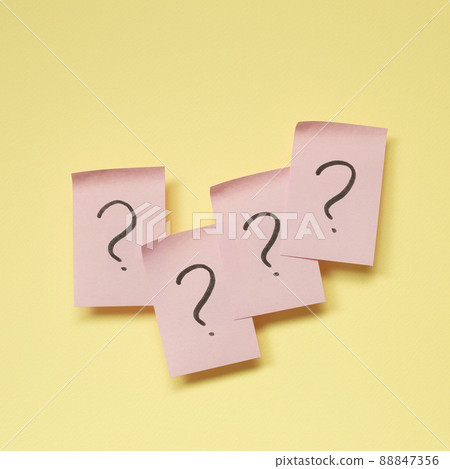 Question mark on pink memo paper on yellow background Question mark on pink memo paper on yellow background 88847356