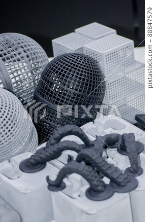 Many different models printed on 3D printer. Gray and black objects printed Many different models printed on 3D printer. Gray and black objects printed 88847579