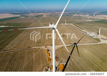 Installing new wind generator, Windmill turbine maintenance, Construction site with cranes for assembling windmill tower, Wind power and renewable energy 88848807