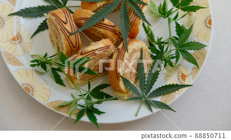 Sweet roll with marijuana oil on white plate. Cannabis kitchen 88850711