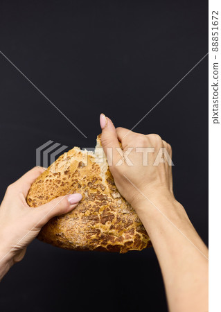 Woman holding tasty fresh bread, close up 88851672