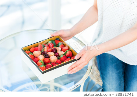 Female with an assortment of fruits 88851741