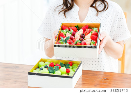 Female with an assortment of fruits 88851743