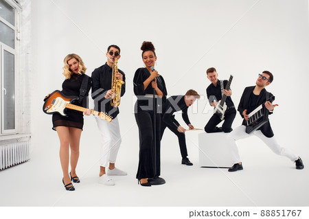 Portrait of diverse group of young people musical band playing with instruments - isolated on white background. 88851767