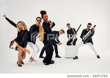 Portrait of diverse group of young people musical band playing with instruments - isolated on white background. Portrait of diverse group of young people musical band playing with instruments - isolated on white background. 88851768