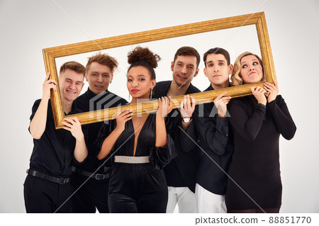 studio portrait of Beautiful young diverse group of friends isolated on white background in the frame for a picture, goofy face, good mood 88851770